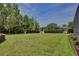 This lovely backyard is lush, spacious, and features manicured hedges at 525 Hebrides Ct, Apopka, FL 32712