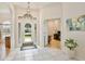 Bright foyer featuring tile flooring, glass-paneled front door, and an open view into the office at 525 Hebrides Ct, Apopka, FL 32712