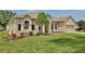 Charming single-story home with well maintained lawn and beautiful landscaping including flowering plants at 525 Hebrides Ct, Apopka, FL 32712