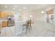 Bright, open kitchen with bar seating, stainless steel appliances and easy access to the dining area at 525 Hebrides Ct, Apopka, FL 32712
