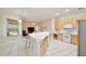 Spacious kitchen features a breakfast bar, stainless steel refrigerator and adjoining living area at 525 Hebrides Ct, Apopka, FL 32712