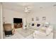 Comfortable living room with plush seating, ceiling fan, and tile flooring throughout the space at 525 Hebrides Ct, Apopka, FL 32712