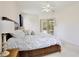 Bright main bedroom featuring a ceiling fan, carpeted floor, and access to the outdoor patio at 525 Hebrides Ct, Apopka, FL 32712