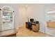 Bright office space with wood floors, arched window, and adjacent bathroom entrance at 525 Hebrides Ct, Apopka, FL 32712
