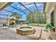 The pool area features screened enclosure, fountain, brick flooring, and fireplace at 525 Hebrides Ct, Apopka, FL 32712
