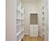 Organized walk-in closet with built-in shelving units and rods for ample storage at 525 Hebrides Ct, Apopka, FL 32712