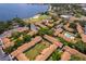 Aerial view of community near the water featuring a pool, tennis courts and lake access at 5325 Hansel Ave # E-15, Orlando, FL 32809