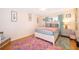Charming bedroom with a comfortable bed, colorful rug, and warm, inviting decor at 5325 Hansel Ave # E-15, Orlando, FL 32809