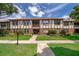 Charming condo with Tudor-style architecture, beautiful landscaping, and inviting walkway to the front entrance at 5325 Hansel Ave # E-15, Orlando, FL 32809