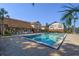 Community pool with outdoor seating and brick buildings in the background at 5325 Hansel Ave # E-15, Orlando, FL 32809