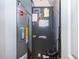 Utility room featuring a water heater and furnace, ensuring home comfort and efficiency at 5325 Hansel Ave # E-15, Orlando, FL 32809
