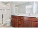 Bathroom with double sink vanity, full mirror, and shower with glass door at 6013 Blue Lily Way, Winter Garden, FL 34787