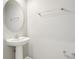 Bathroom featuring pedestal sink, chrome fixtures, and oval mirror at 6013 Blue Lily Way, Winter Garden, FL 34787