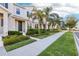 Attractive townhome showcasing a neat sidewalk and well-manicured greenery, offering a pleasant curb appeal at 6013 Blue Lily Way, Winter Garden, FL 34787