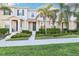 Charming two-story townhome featuring lush landscaping and a welcoming entrance, perfect for a serene suburban lifestyle at 6013 Blue Lily Way, Winter Garden, FL 34787