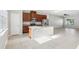 Bright kitchen area featuring an island, tile flooring, stainless steel appliances, and open layout for modern living at 6013 Blue Lily Way, Winter Garden, FL 34787