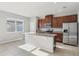 Bright kitchen features granite countertops, stainless steel appliances, and a spacious island at 6013 Blue Lily Way, Winter Garden, FL 34787
