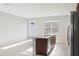 Bright kitchen features a functional island, a tile floor, and outdoor access at 6013 Blue Lily Way, Winter Garden, FL 34787