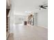 Expansive living area showcasing tile flooring, a ceiling fan, and a kitchen view, creating an inviting space at 6013 Blue Lily Way, Winter Garden, FL 34787