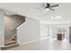 Spacious living area featuring tile flooring, staircase, and partial kitchen view with natural light, great for entertaining at 6013 Blue Lily Way, Winter Garden, FL 34787