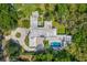 Aerial view of a large home with a circular driveway, lush landscaping, and a private pool area at 608 E Club Cir, Longwood, FL 32779