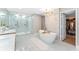 Beautiful bathroom with walk-in shower, dual vanities, and access to the walk-in closet at 608 E Club Cir, Longwood, FL 32779