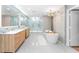 A luxurious bathroom with a freestanding tub, walk-in shower, and dual vanities at 608 E Club Cir, Longwood, FL 32779