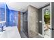 Modern bathroom features a sleek glass shower, contemporary vanity, and stylish gray marble tiling at 608 E Club Cir, Longwood, FL 32779
