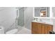 Elegant bathroom features a glass shower, marble tile, wood vanity, and a modern, illuminated mirror for added ambiance at 608 E Club Cir, Longwood, FL 32779