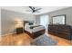 Bedroom with hardwood floors, fan, and ensuite bathroom at 608 E Club Cir, Longwood, FL 32779