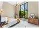 Bright bedroom featuring a large window with lush views, neutral tones, and a ceiling fan for comfort at 608 E Club Cir, Longwood, FL 32779