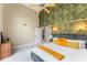 Spacious bedroom boasts a vaulted ceiling, decorative wallpaper, modern lighting, and ensuite access at 608 E Club Cir, Longwood, FL 32779
