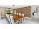 Dining room featuring a long wood table, modern chandelier, a wall with an animal print, and view of patio at 608 E Club Cir, Longwood, FL 32779