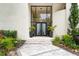Elegant entrance featuring a grand glass door and manicured landscaping at 608 E Club Cir, Longwood, FL 32779