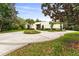 Beautiful circular driveway and landscaping leading up to a stunning modern home at 608 E Club Cir, Longwood, FL 32779