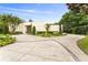 Sprawling driveway and manicured landscaping accent this modern home's exterior at 608 E Club Cir, Longwood, FL 32779