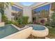 Outdoor view of the home featuring a unique fountain, lush garden, and expansive windows at 608 E Club Cir, Longwood, FL 32779