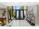 Spacious foyer with sleek tile flooring and a modern glass front door at 608 E Club Cir, Longwood, FL 32779