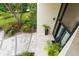 Inviting front entrance with stone walkway, lush landscaping, and contemporary architectural design at 608 E Club Cir, Longwood, FL 32779