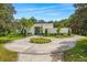 Stunning home exterior with circular driveway, lush landscaping, and modern architectural design at 608 E Club Cir, Longwood, FL 32779