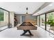 Bright game room with pool table, modern lighting, bar and outdoor access, perfect for entertaining guests at 608 E Club Cir, Longwood, FL 32779