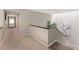 Carpeted hallway featuring a staircase with a dark railing and white risers at 608 E Club Cir, Longwood, FL 32779