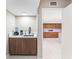Convenient wet bar area with sink, storage, and easy access to the modern kitchen at 608 E Club Cir, Longwood, FL 32779