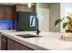 Bright kitchen boasts marble countertop, stainless steel sink, and wood cabinets with under cabinet lighting at 608 E Club Cir, Longwood, FL 32779