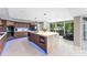 Contemporary kitchen boasts a large island, wood cabinetry, and seamless access to the outdoor patio at 608 E Club Cir, Longwood, FL 32779