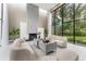Inviting living room with a fireplace, neutral walls, tile floors, modern sofas, and a large window with outside views at 608 E Club Cir, Longwood, FL 32779