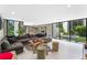 Spacious living room featuring contemporary decor, ample seating, and a view of the outdoor spa at 608 E Club Cir, Longwood, FL 32779