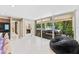 Bright living area offers views of the lanai, pool, and outdoor entertaining area, enhancing indoor-outdoor living at 608 E Club Cir, Longwood, FL 32779
