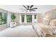 Large primary bedroom with an oversized ceiling fan and window views of the surrounding yard at 608 E Club Cir, Longwood, FL 32779