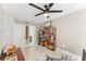 Inviting office space with black ceiling fan, a bookshelf, and a view to the en suite bathroom for convenience at 608 E Club Cir, Longwood, FL 32779